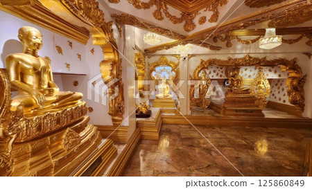 Ornate Golden Buddha Statues in Luxurious Decorative Temple Interior 125860849
