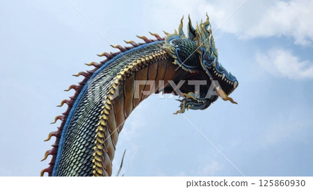 Majestic Colorful Dragon Sculpture Against Blue Sky Background Majestic Colorful Dragon Sculpture Against Blue Sky Background 125860930