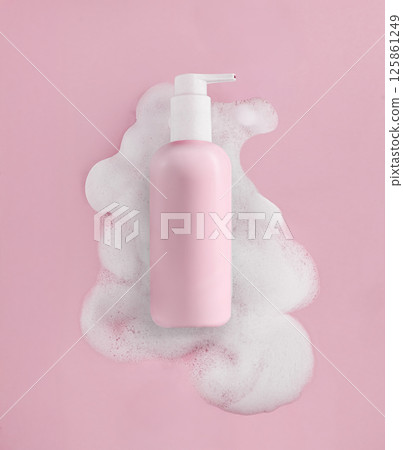 Elegant Pink Pump Bottle Beautifully Surrounded by Soft Cosmetic Foam 125861249