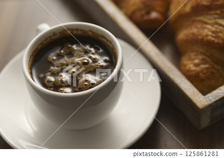 fresh croissant and cup of espresso 125861281