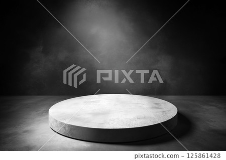 A clean and minimalist stage setup with dramatic overhead lighting against a dark backdrop, creating a moody and professional atmosphere. 125861428