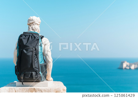 Classical Greek statue with modern hiking backpack. Travel, vacation, hiking, sport, exploration, wanderlust. Tourist with bag, travel more concept. Greece tourism, visit Greece. 125861429