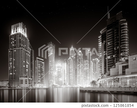 Skyscrapers and bridge over water, black and white style, city background, Dubai Marina bay UAE 125861854