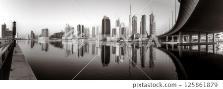 Skyscrapers and bridge over water, black and white style, city background, Dubai Marina bay UAE 125861879