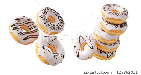 Donuts with white chocolate glaze, sprinkles, white drizzle, and dots isolated on white transparent background 125862011