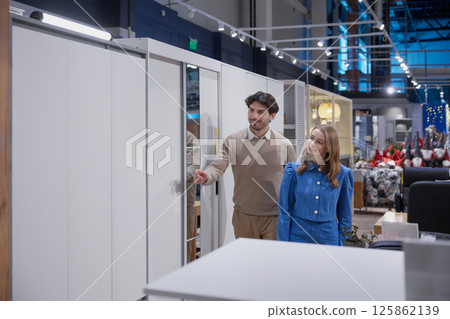 A couple enjoys exploring a modern contemporary furniture showroom, embracing creativity and style A couple enjoys exploring a modern contemporary furniture showroom, embracing creativity and style 125862139