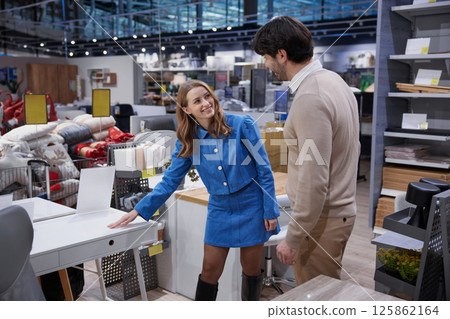A couple is exploring and shopping for stylish office furniture in a modern retail store A couple is exploring and shopping for stylish office furniture in a modern retail store 125862164