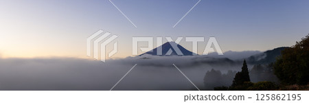 Serene early morning panorama of Mount Fuji surrounded by mist as the first sunlight 125862195