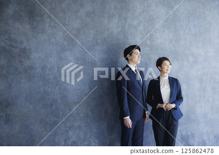 Men and women in suits standing 125862478