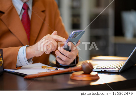 Male lawyer working at table at home office in the morning. Male lawyer working at table at home office in the morning. 125862479