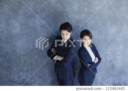 Men and women in suits standing 125862485
