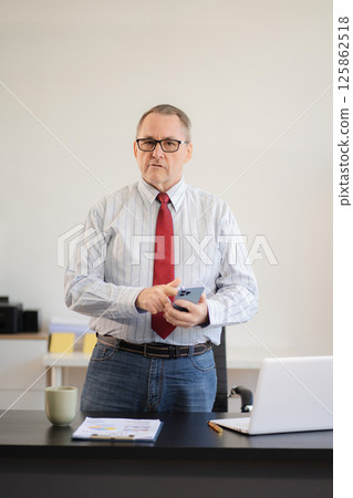 Businessman using laptop computer in office. success man, entrepreneur, small business owner working online. Businessman using laptop computer in office. success man, entrepreneur, small business owner working online. 125862518