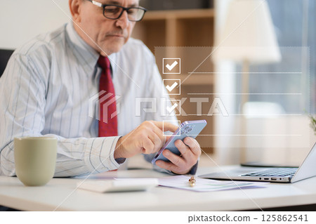 Businessman using tablet to do online checklist survey, doing assessment online survey answer test questions Digital form. Businessman using tablet to do online checklist survey, doing assessment online survey answer test questions Digital form. 125862541