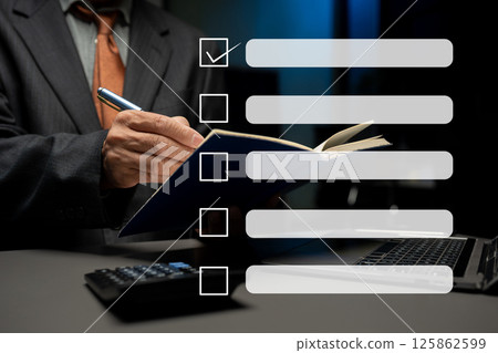 Business performance checklist concept, businessman using tablet and laptop doing online checklist survey, filling out digital form checklist. 125862599