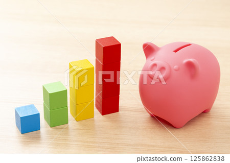 Piggy bank and graph made of building blocks 125862838