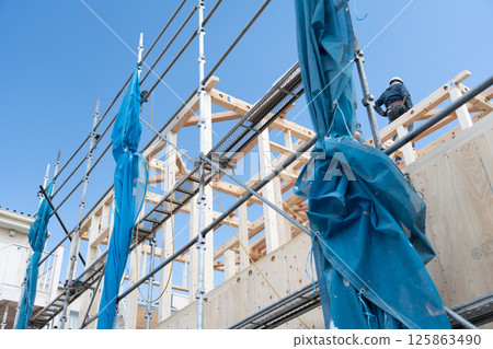 Building up a two-story wooden house Building up a two-story wooden house 125863490