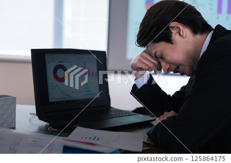 A man in a suit having trouble at work A man in a suit having trouble at work 125864175