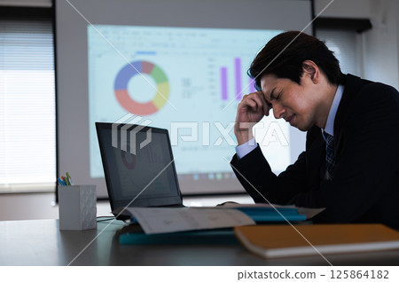 A man in a suit having trouble at work A man in a suit having trouble at work 125864182