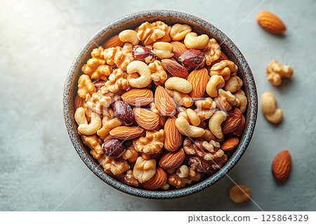 Healthy mix of almonds, walnuts and cashews in a bowl. Healthy mix of almonds, walnuts and cashews in a bowl. 125864329