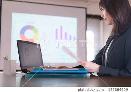 A young woman in a suit working A young woman in a suit working 125864699