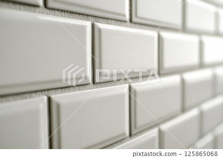 Ceramic tiles with a glossy finish and beveled edges set into horizontal brickwork. The sleek and clean wall design is ideal for kitchens and bathrooms with a minimalist or modern aesthetic. Banner Ceramic tiles with a glossy finish and beveled edges set into horizontal brickwork. The sleek and clean wall design is ideal for kitchens and bathrooms with a minimalist or modern aesthetic. Banner 125865068