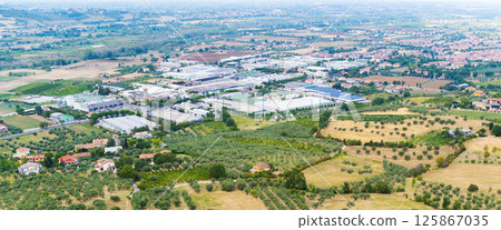 Aerial view of scenic rural landscape with farmlands and industrial buildings in Verucchio, Italy 125867035