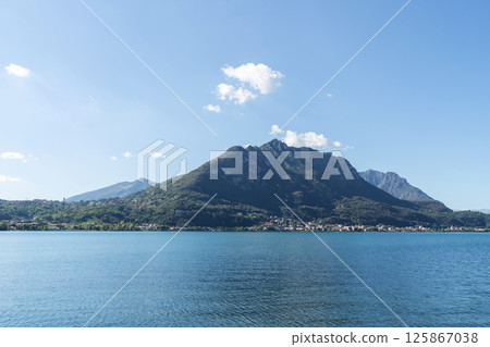 Calm Lake with Mountain and Clear Sky near Lecco, lake Como Calm Lake with Mountain and Clear Sky near Lecco, lake Como 125867038
