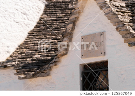 Stone Trulli house with "Monte Pasubio" sign Stone Trulli house with "Monte Pasubio" sign 125867049