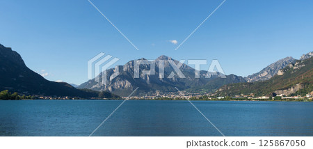 Calm Lake with Mountain and Clear Sky near Lecco, lake Como Calm Lake with Mountain and Clear Sky near Lecco, lake Como 125867050