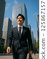 A male new employee starting a new life in a sunny business district 125867157