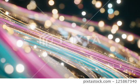 Colorful lights streak across dark background creating dynamic, energetic abstract pattern 125867340