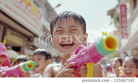 Thai Children celebrating Songkran festival with water fights on street 125867342