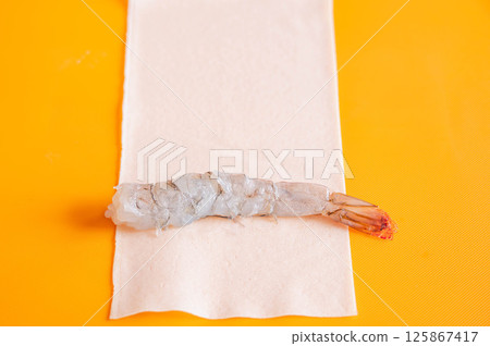 Shrimp wrapped in spring roll wrappers 125867417