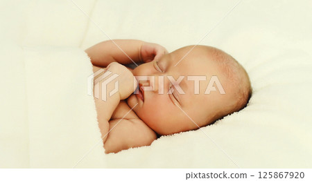 Close up sweet baby, infant sleeping lying on white bed at home 125867920
