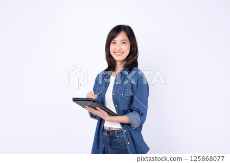 Southeast asian woman is small business owner working creatively in retail and online store startup industry, happily managing her shopping and business tasks Southeast asian woman is small business owner working creatively in retail and online store startup industry, happily managing her shopping and business tasks 125868077