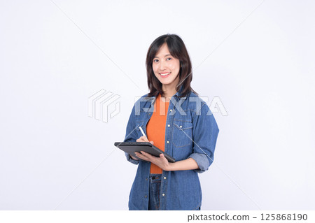 Southeast asian woman small business owner retail shopping startup creative industry online store concept with smiling young female entrepreneur holding digital tablet and stylus Southeast asian woman small business owner retail shopping startup creative industry online store concept with smiling young female entrepreneur holding digital tablet and stylus 125868190