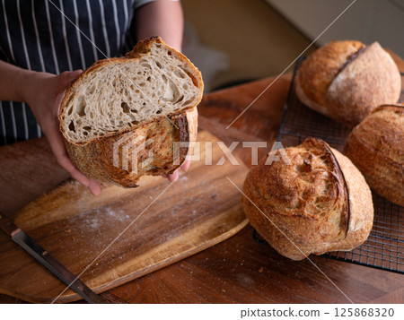 Baker Presenting Homemade Sourdough. 125868320