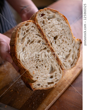 Baker Presenting Homemade Sourdough. Baker Presenting Homemade Sourdough. 125868325