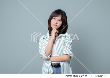 Southeast asian woman thoughtfully considering ideas for her small business startup in creative retail industry while planning online store for shopping success 125868465
