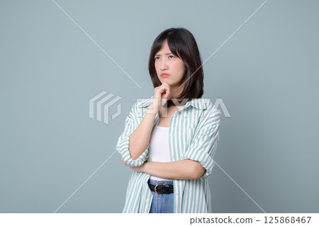 Southeast asian woman with thoughtful expression is considering ideas for her small business startup in creative retail industry while shopping online store options Southeast asian woman with thoughtful expression is considering ideas for her small business startup in creative retail industry while shopping online store options 125868467