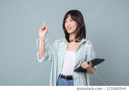 Southeast asian woman small business owner is creatively using digital pen and tablet for her online retail startup store in creative industry with confident smile Southeast asian woman small business owner is creatively using digital pen and tablet for her online retail startup store in creative industry with confident smile 125868544