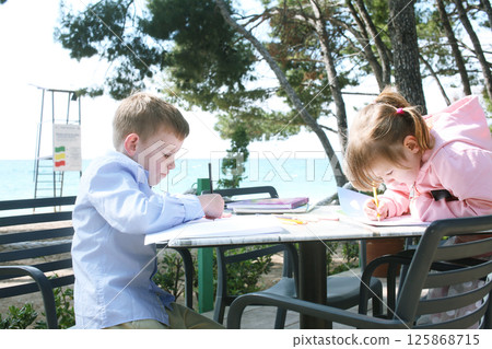 little cute boy and girl outside in cafe drawings, lifestyle family 125868715