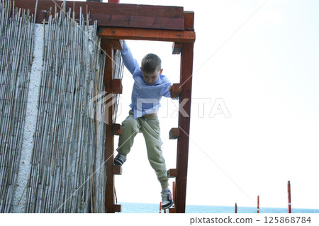 little cute boy playing on beach, lifestyle people concept 125868784