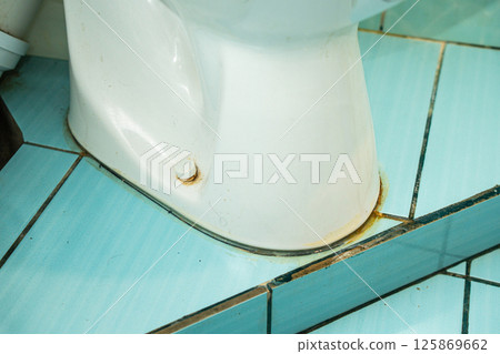 Messy toilet in a dirty bathroom. Dirty joints between the tiles in the bathroom. Unclean toilet, yellow stains 125869662