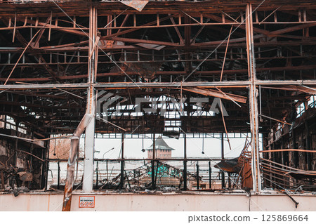 Industrial building after fire. A metal no smoking sign attached to a building 125869664