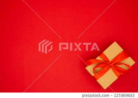 Gift box tied with red ribbon. Holiday banner. Place for text, banner, top view. The concept of the weddings, birthday and other holidays 125869683