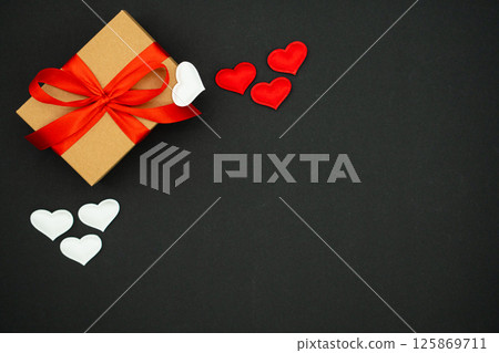 Beautiful valentines day background, with craft box with red and white hearts on black background 125869711