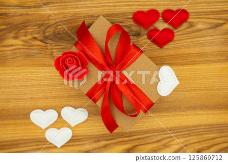 Gift box on the wooden background. Valentine's day celebration Gift box on the wooden background. Valentine's day celebration 125869712