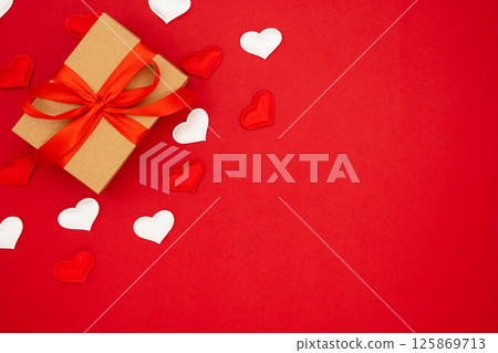 Valentine's Day background. Red and white hearts and box for St. Valentine's day gift. Concept of Valentine's, anniversary, mother's day and birthday greeting, copy space, top view Valentine's Day background. Red and white hearts and box for St. Valentine's day gift. Concept of Valentine's, anniversary, mother's day and birthday greeting, copy space, top view 125869713