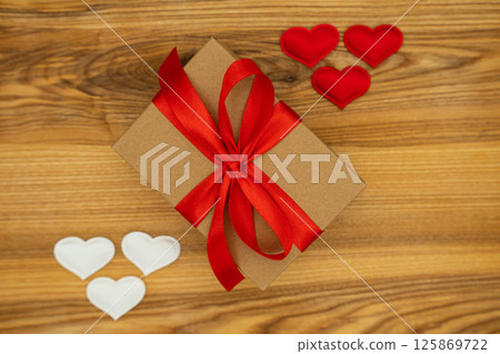 Gift box and hearts on wood background. Valentine's day 125869722